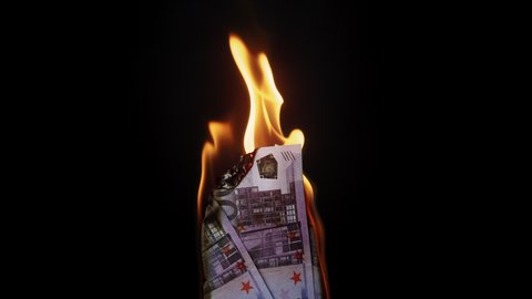 Burning of 500 euro banknotes on black background. Flame of fire from a bundle of cash. Financial crisis and depressed economy. Paper money loss concept. 
