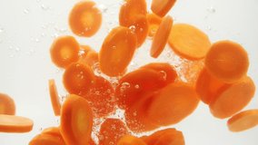 Slow Motion of fresh orange carrot slices falling into water splash on white background, Vegetables for health. - Powered by Shutterstock - Get 15% off with code: PIKWIZARD15