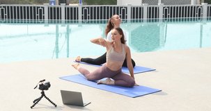 Two Attractive young caucasian woman doing yoga practice video online training 
