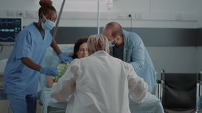 Obstetrics doctor and african american nurse delivering child in hospital ward at maternity. Caucasian pregnant woman with painful contractions pushing for childbirth with father of child - Powered by Shutterstock - Get 15% off with code: PIKWIZARD15