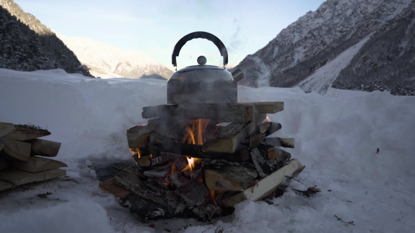 kettle on a camping trip on a campfire in winter 4k
