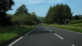 Car point of view, POV, driving down the hill stretch of road A40 in a beautiful English countryside scenery. - Powered by Shutterstock - Get 15% off with code: PIKWIZARD15