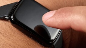 Closeup male finger tapping on screen smartwatch wearing technology for sport, health checking email making phone video 4k