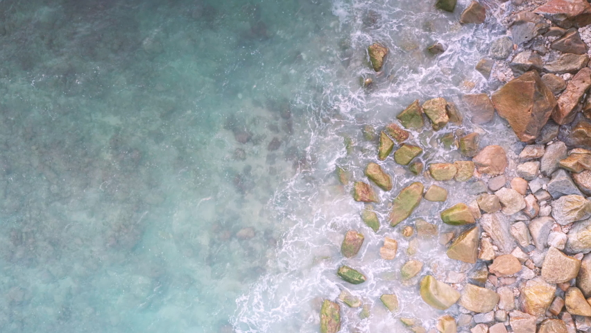 4K Aerial drone top down view bird eye view of sea blue waves break on rock and sand. Beautiful of sea water wave come to beach. Phuket Thailand tropical beach | Shutterstock HD Video #1076589806