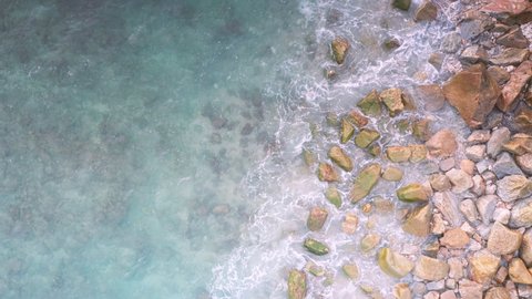 4K Aerial drone top down view bird eye view of sea blue waves break on rock and sand. Beautiful of sea water wave come to beach. Phuket Thailand tropical beach