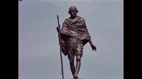 India 1950s: Man walks off gangplank. Statue of Mahatma Gandhi. 1947 London Times, "Power Handed Over In India". A mosque.