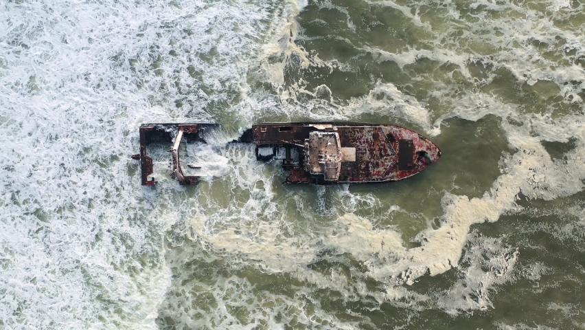 Flight over the shipwreck in the Atlantic ocean on Skeleton Coast near Swakopmund in Namibia, Africa. Top view. UHD 4k drone video footage Royalty-Free Stock Footage #1076600327