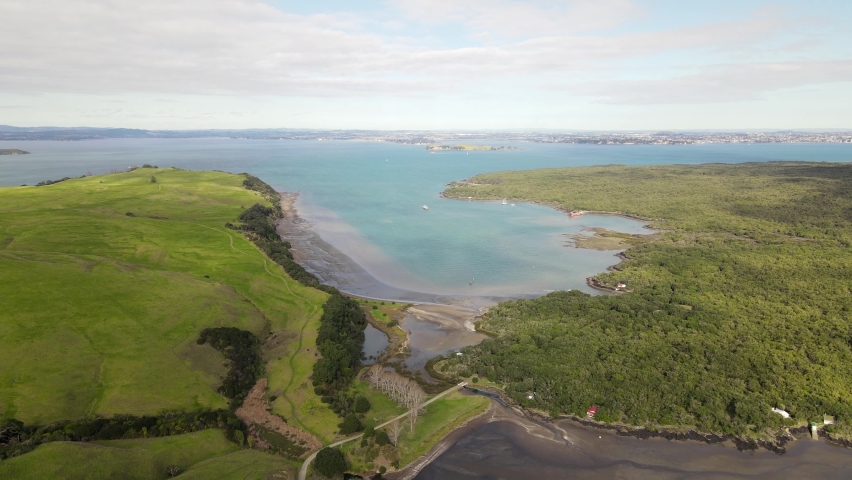 The thin land bridge link between Rangitoto Island and Motutapu Island, New Zealand. Aerial view