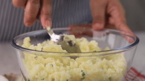 Asian Chef Hand Mashed Potato in Clear Bowl using Spoon, Step by Step Making Homemade Food.  - Powered by Shutterstock - Get 15% off with code: PIKWIZARD15