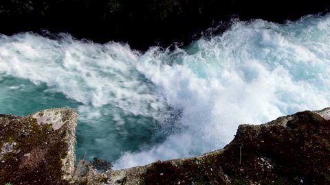 Turbulent whitewater passing through a narrow passage on the Waikato River at Huka Falls in Taupo, New Zealand Aotearoa