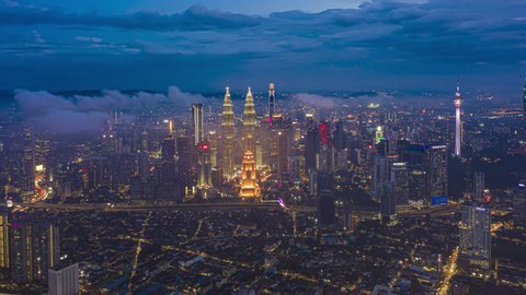 Malaysia Time lapse: Kuala Lumpur aerial view during twilight with low clouds overlooking KL city skyline in Federal Territory, Malaysia. 