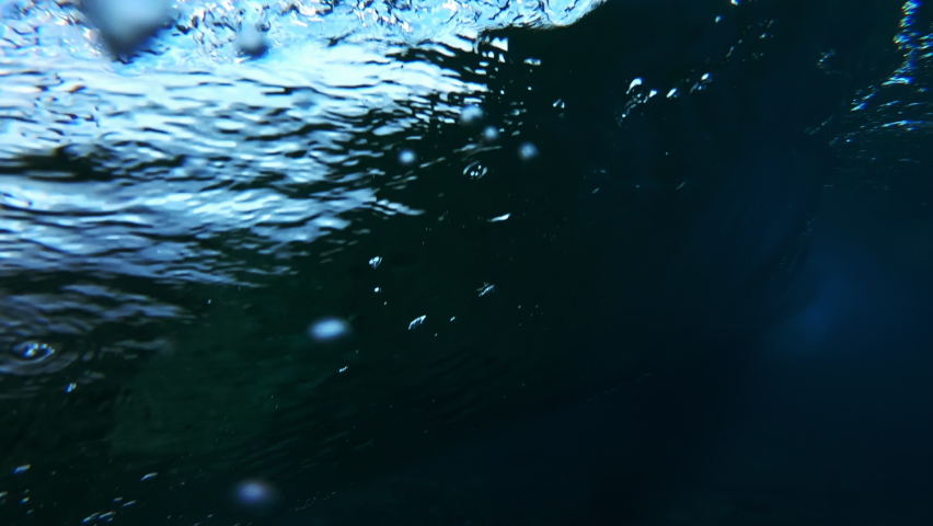Wave rolls and breaks. Underwater view of the ocean wave rolling and breaking over the coral reef Royalty-Free Stock Footage #1076619455