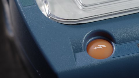 Close-up of orange active button on a heart defibrillator.