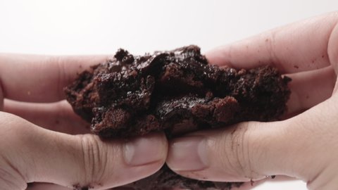 Macro Shot, Juicy Fudge Chocolate Brownie Cookie Squeezed by Male Hands