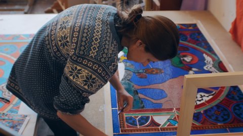 Novosibirsk region, September 18, 2020. The artist collects the details of the stained glass window. Classic mosaic, handmade. drawing on pieces of stained glass
