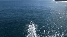 Speedboat moving to horizon in ocean