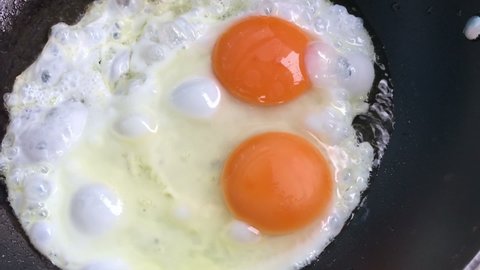 Сooking two fried eggs close up
