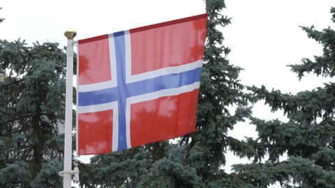 Ungraded: National flag of Norway on the flagpole. Norwegian official flag waving in the wind. Ungraded H.264 from camera without re-encoding.