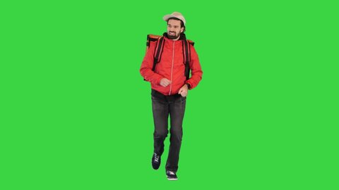 Delivery man running with thermo backpack on a Green Screen, Chroma Key.