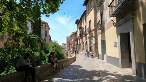 Alhambra, Granada, Spain, July 20, 2021: Paseo de los tristes in granada, main street point of view of people walking by la alhambra. 