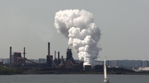 Hamilton, Ontario, Canada July 2021 Massive air pollution from heavy industry manufacturing factories with smokestacks.