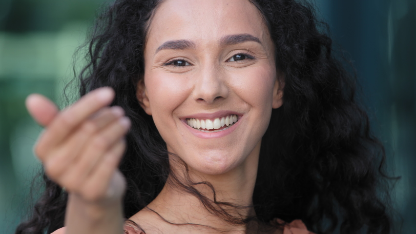 Female portrait outdoors close-up hispanic woman seductive friendly girl flirting lady pointing finger to camera smiling doing gesture of invitation asking to come welcome symbol making choice choose Royalty-Free Stock Footage #1076657000
