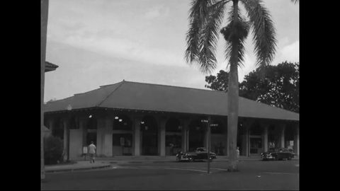 1953 - Cars and people pass by the commissary of Albrook Air Force Base in Balboa, Panama.