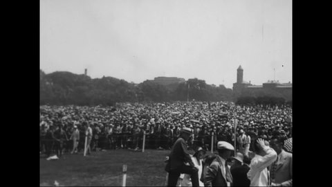 1927 - President Coolidge awards Charles Lindbergh the Distinguished Flying Cross at a ceremony by the Washington Monument in Washington DC.