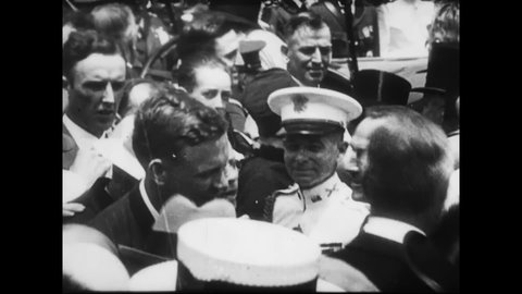 1927 - Charles Lindbergh disembarks the USS Memphis in the Washington DC navy yard, where is he welcomed by his mother and huge crowds.