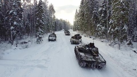 2021 Drone shot, British Army Challenger 2 Tanks drive through Estonia Forest during NATO’s Exercise Winter Camp.
