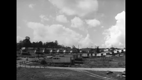 1946 - Black and white employees of the atomic energy plant in Oak Ridge live with their families in cottages, trailers and bunk houses by the plant.