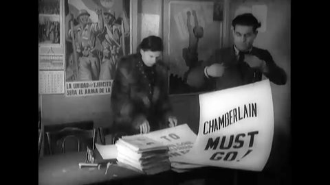 1938 - Londoners prepare protest signs speaking out against Neville Chamberlain's collaboration with Mussolini and Hitler.