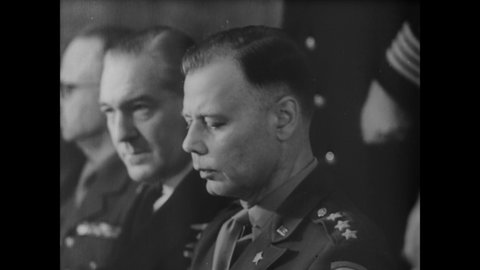 1945 - Nazi General Alfred Jodl and US Army General Walter Bedell Smith sign the papers making Nazi Germany's unconditional surrender official.