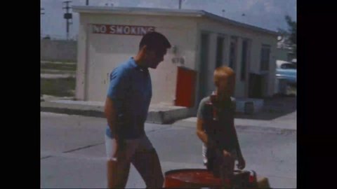 1960s - Wally Schirra and his son arrive at a dock and Schirra leaves on a motorboat.