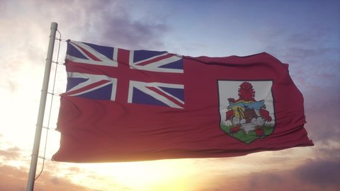 Flag of Bermuda waving in the wind, sky and sun background
