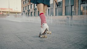 Young beautiful pin up woman in bright clothes rollerblading on roller skates outdoor, dancing near fountains in urban area, tracking shot, slow motion - Powered by Shutterstock - Get 15% off with code: PIKWIZARD15