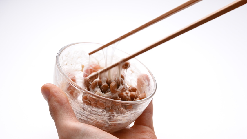 Video of checking the stickiness of natto on a white background. Royalty-Free Stock Footage #1076669663