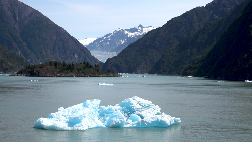 Ice floats floating on the surface of the lake. It is amber water blue. The fjords of Alaska, unique natural landscapes. Alaska, USA. June 2019.
