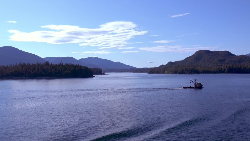 Work boat sailing on the lake. Morning sunlight mapped the surface of the lake. Ketchikan, Alaska is truly the beginning of the "Last Frontier". june 2019, USA