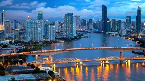 Time lapse 4K of aerial view of Bangkok City skyline by Chao Phraya River in Thailand
