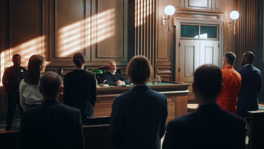 Court of Law and Justice Trial: Imparcial Honorable Judge Pronouncing Sentence, Striking Gavel. Cinematic Shot of Male Lawbreaker in Orange Robe Sentenced to Serve Time in Prison. Hearing Adjourned, Royalty-Free Stock Footage #1076688434