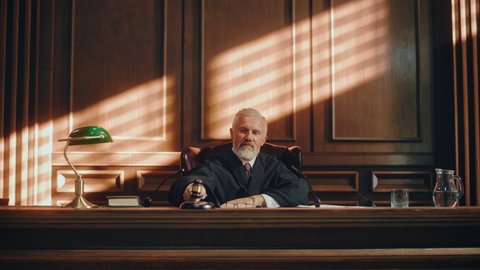 Court of Law and Justice Trial Session: Imparcial Honorable Judge Pronouncing Sentence, Striking Gavel. Focus on Mallet, Hammer. Cinematic Shot of Dramatic Not Guilty Verdict. Static Shot.