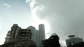 A fast motion of the clouds moving in an urban environment, with a demolished old building and high rises in the background. a 4K video clip, Tel Aviv, Israel.