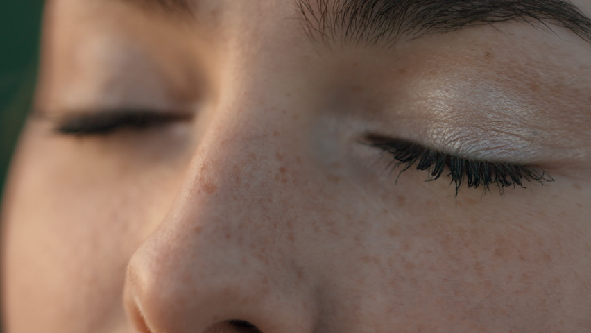 Close up of Girl opening Eyes and looking at the Sunset. Young Girl with Nice Freckles  feeling Pleasure on Nature, Thoughtfully looking ahead  Royalty-Free Stock Footage #1076705936