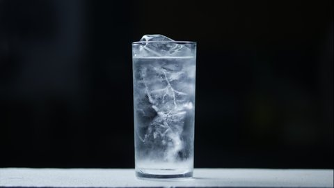 Close-up timelapse of melting ice cubes in a small glass,Ice melting in transparent glass,water in transparent glass