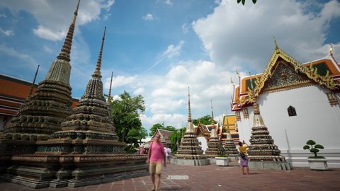 BANGKOK - MAY 07, 2018: Time lapse shot of Wat Phra Chetuphon (Wat Pho) inner temple yard, people silhouettes run around Phra Chedi Rai buildings. Beautiful and interesting place, famous landmark