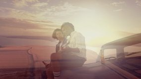 Animation of african american couple sitting on car drinking beers at beach over sunset landscape. spending free time together, happy holidays and free time, digitally generated video.