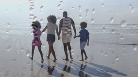Animation of happy african american family walking at beach holding hands over droplets. nature, holiday and summer fun, digitally generated video. - Powered by Shutterstock - Get 15% off with code: PIKWIZARD15