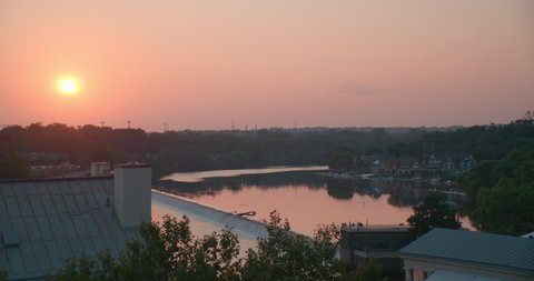 Philadelphia, PA USA - July 26 2021: A gorgeous summer sunset over the Schuylkill river.  Boathouse Row can be seen in the distance.