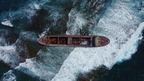 Aerial drone shot of cargo shipwreck in Paphos with waves Cyprus island 